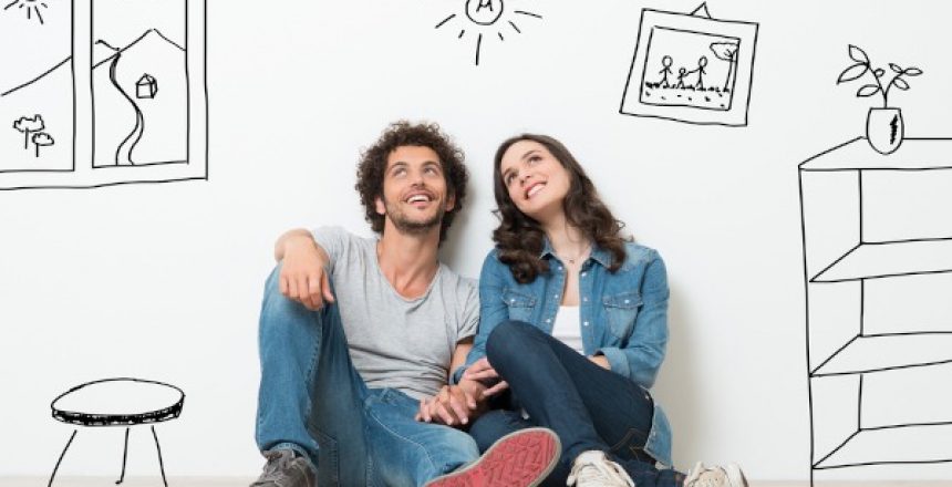 Portrait,Of,Happy,Young,Couple,Sitting,On,Floor,Looking,Up